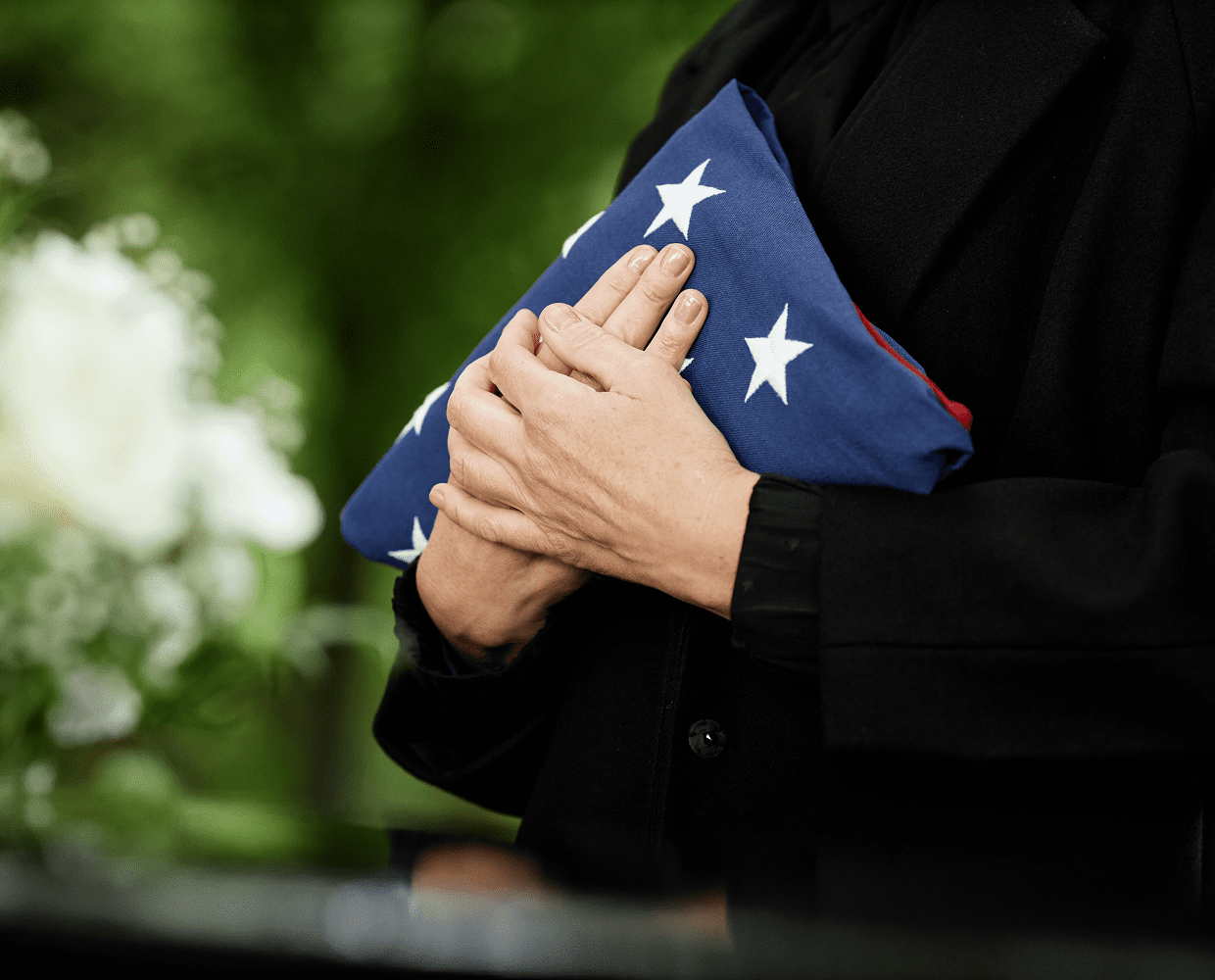 Hands clutching patriotic flag at ceremony